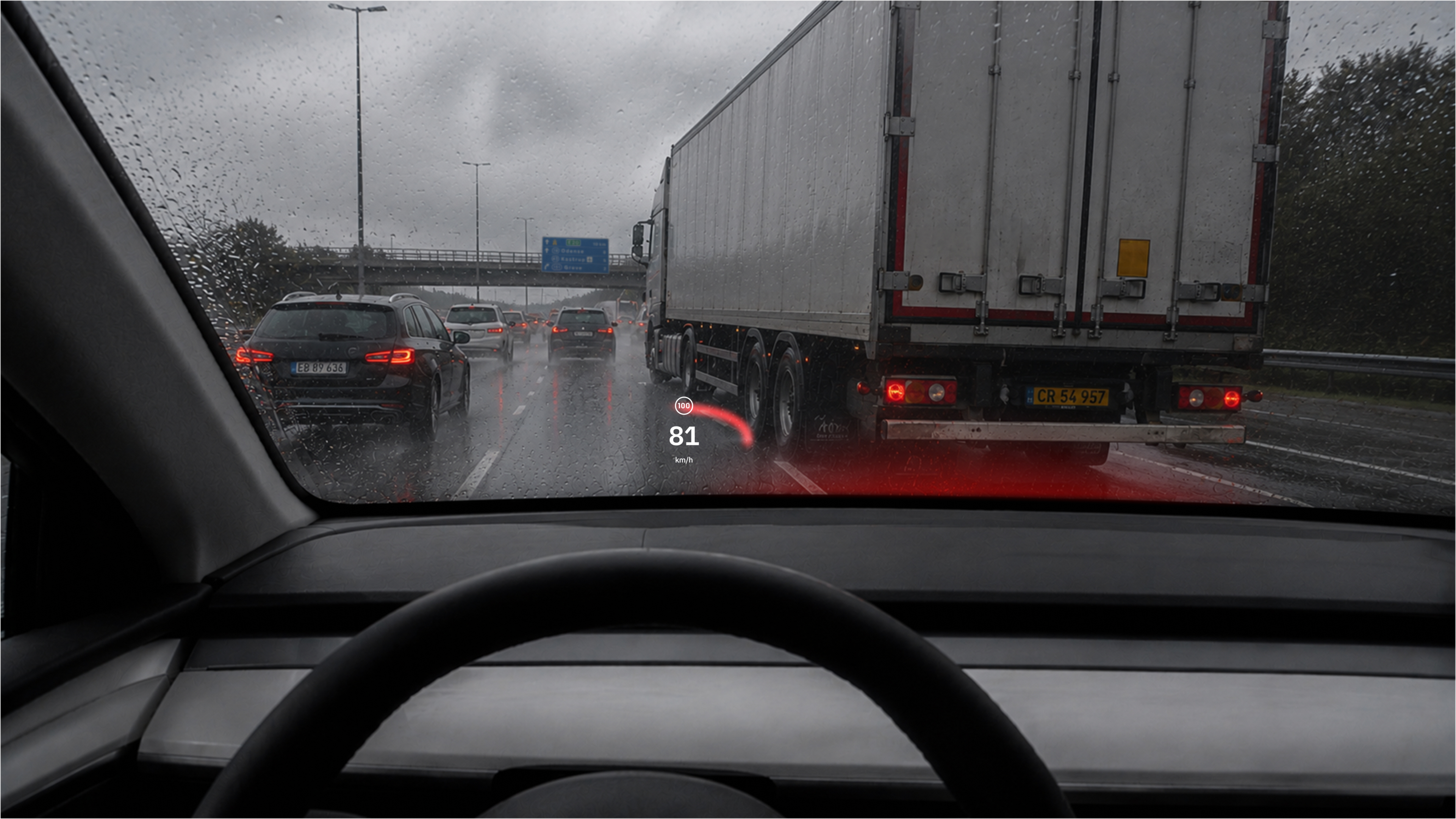 Rainy motorway view with a reduced head-up display highlighting a braking hazard ahead